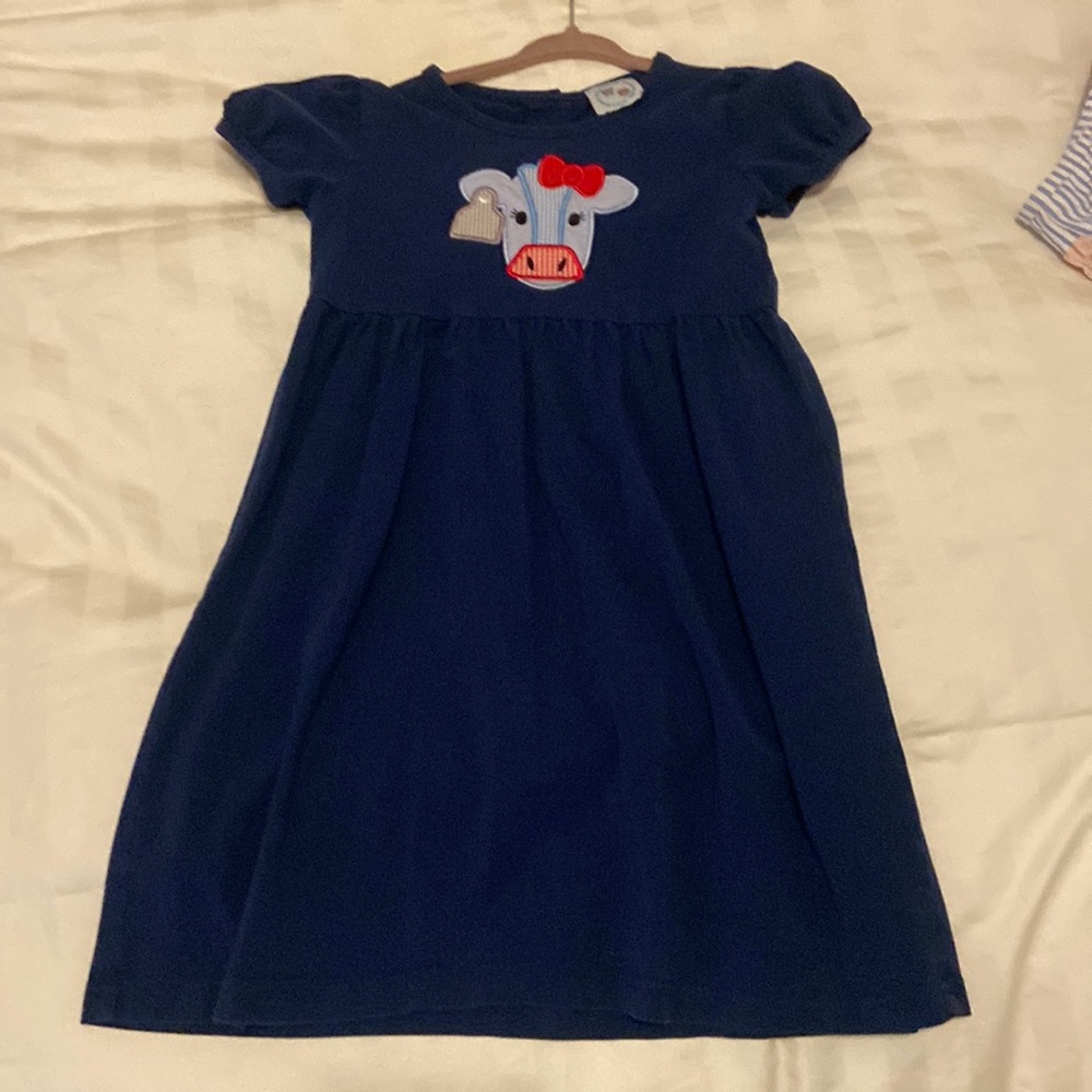 Navy blue short sleeved cotton jersey dress with cow appliqué.